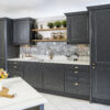 Bianco Lasa Porcelain worktops and matching splashback in a dark shaker kitchen, shown as a wide angle room view