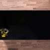 Magma Black Porcelain worktop slab shown from above with a deep black surface on a wood background