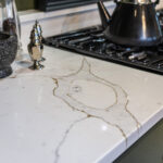 Gold Calacatta worktop with hob cut out displaying bold warm veining