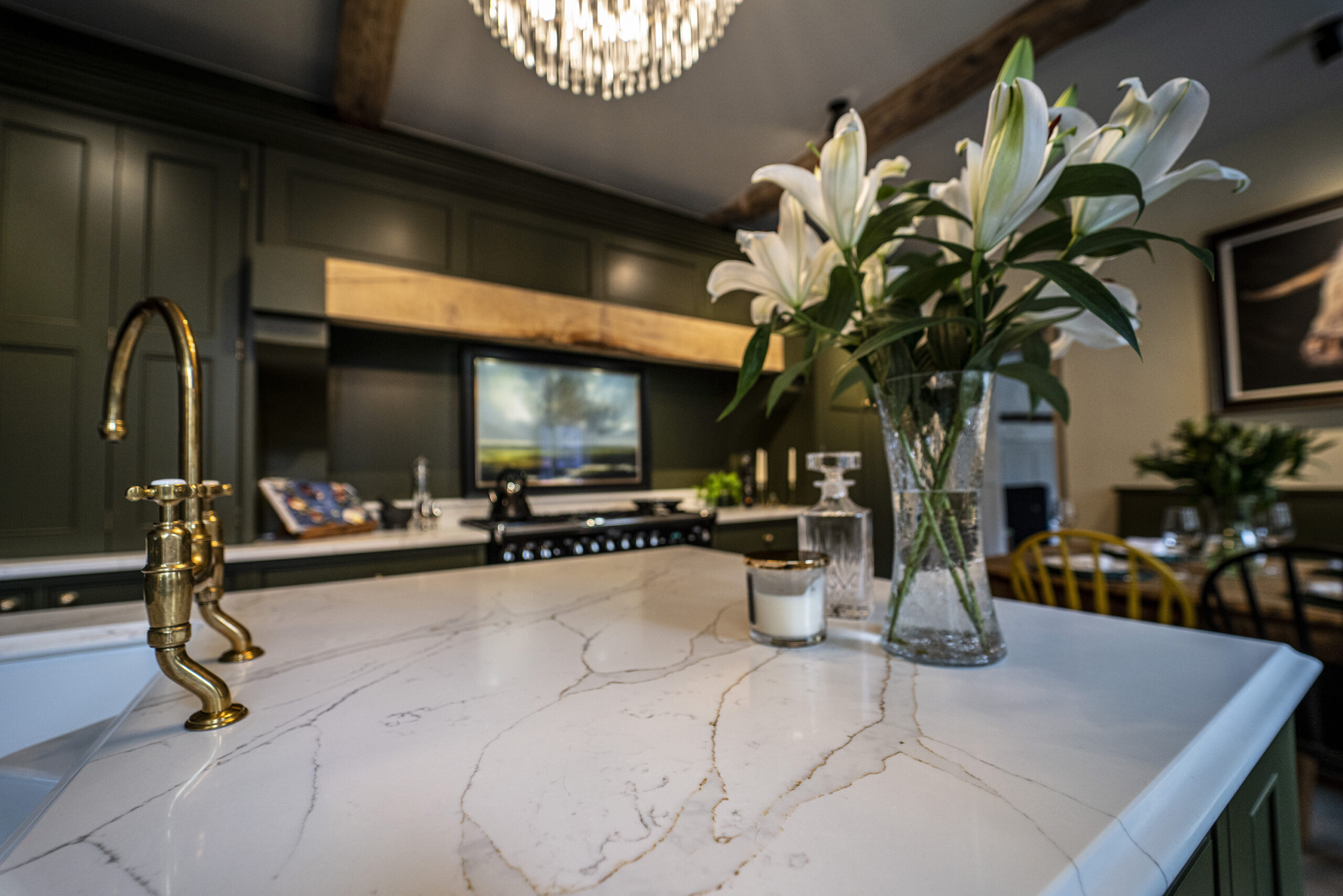 Gold Calacatta kitchen island with floral arrangement and warm natural veining