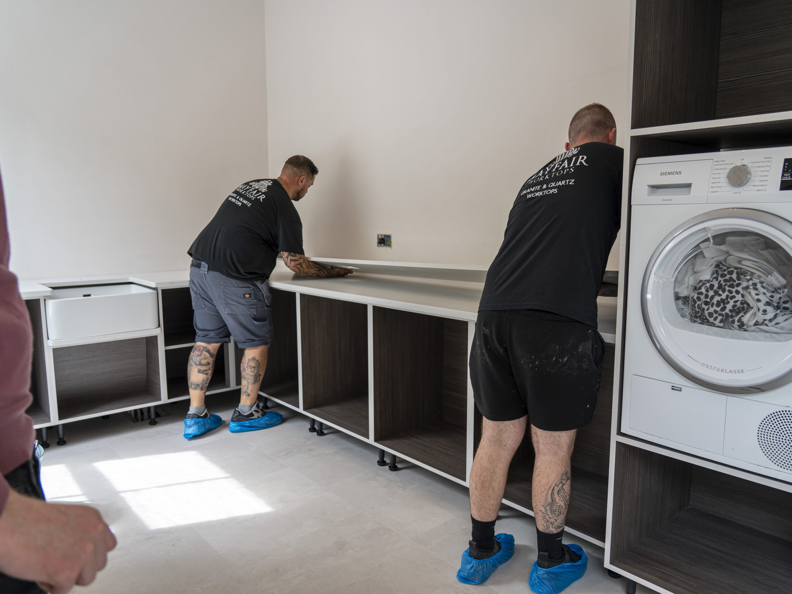 Installation process of Carrara Quartz worktops in a modern home